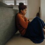 10 signs of anxiety - anxious person sitting behind the couch